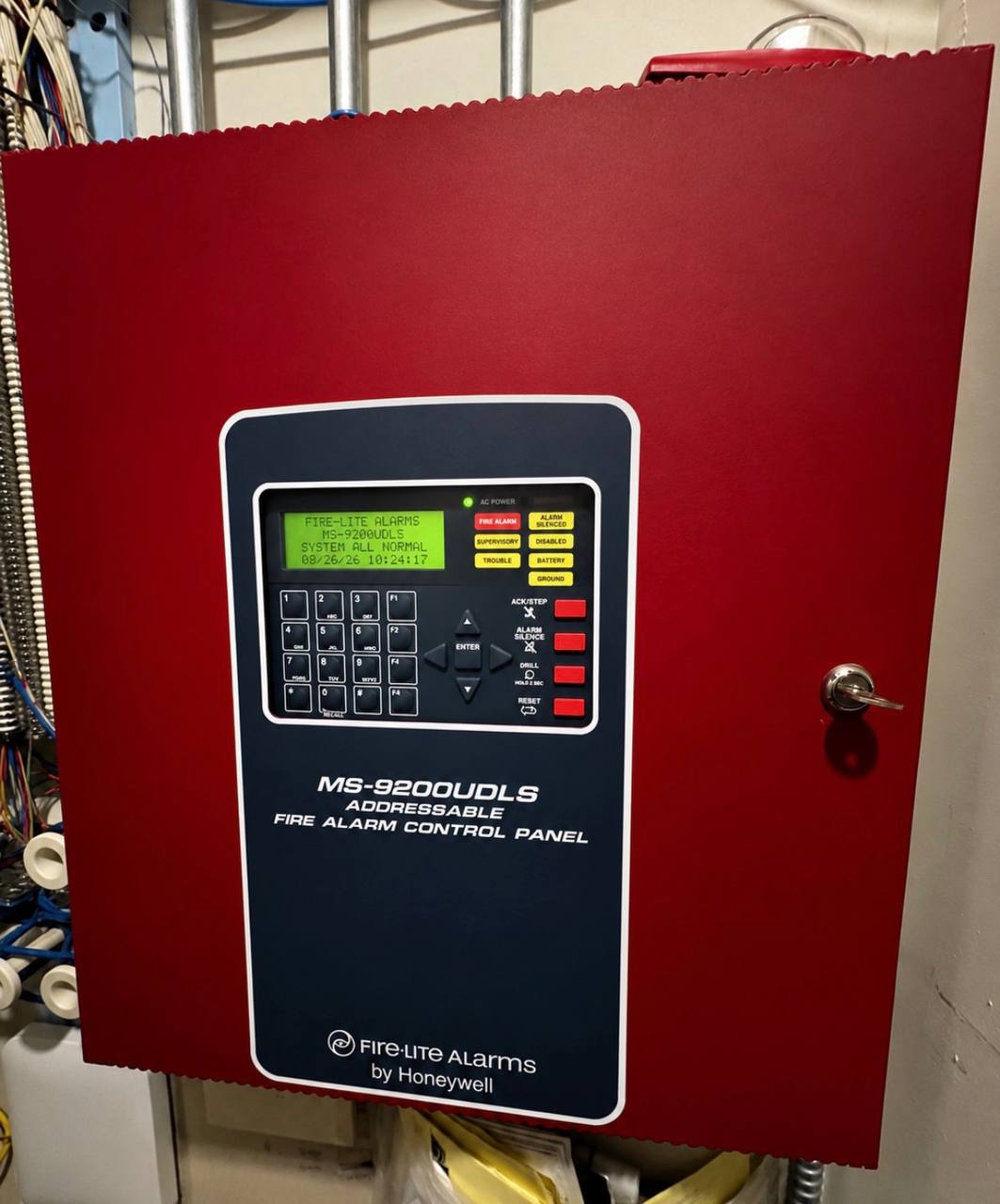 Fire-Lite MS-9200UDLS addressable fire alarm control panel showing system all normal with clean conduit installation
